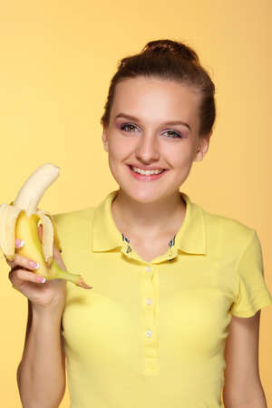 Beautiful young woman with bananas. Tropical fruits.の写真素材