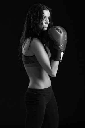 girl with boxing gloves on a black backgroundの写真素材