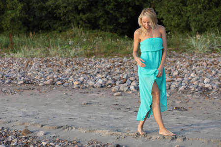 Beautiful blonde young women in blue dressの写真素材