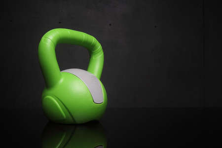 green kettlebell weight on a black backgroundの写真素材
