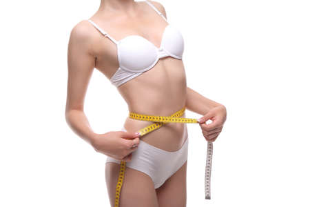 woman with measure tape isolated on whiteの写真素材