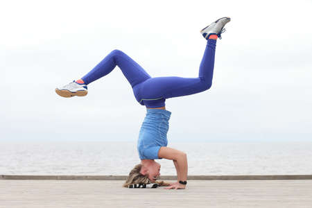 Woman doing yoga at the seaの写真素材