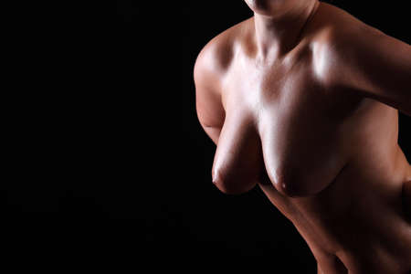 Sexual big female breast on black backgroundの写真素材