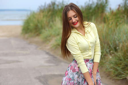 girl with a light summer dress outdoors on a summer day