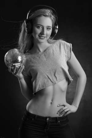 sexy blond DJ is posing with sphereの写真素材