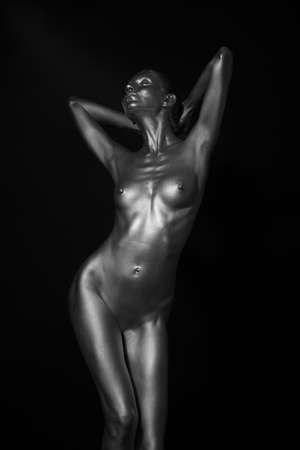 naked female body in a silver body paintingの写真素材