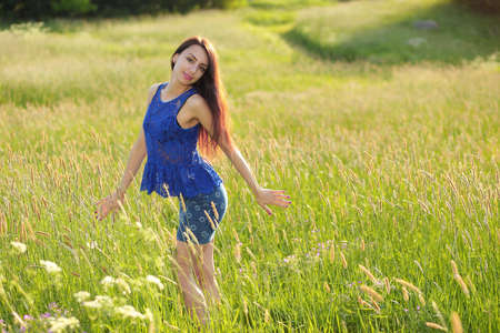 Beautiful teenage model girl in dress enjoying natureの写真素材