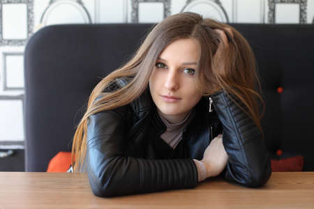 A girl in a cafeteria. Portrait of a young girlの写真素材