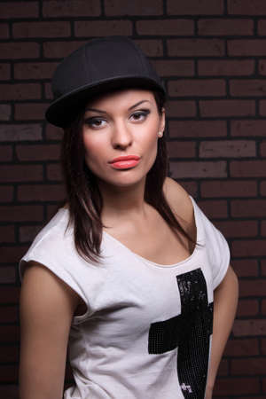 portrait of a beautiful girl in a baseball capの写真素材