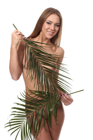 Nude body of the beautiful young woman. Girl body covered with leavesの写真素材