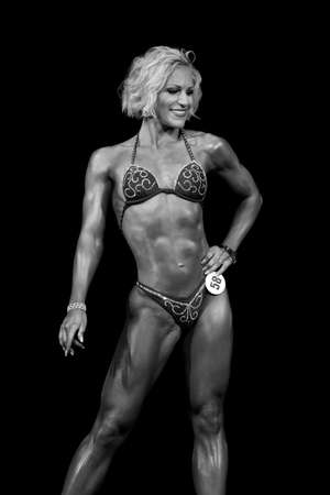 muscular young fitness model posing in competitionsの写真素材