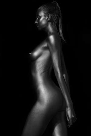 young sexy slender lady painted with silver paintの写真素材