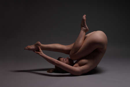 young nude beautiful female body on a dark backgroundの写真素材