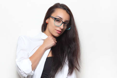 young beautiful girl in stylish glasses on a light background