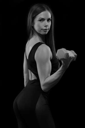 fitness woman in sportswear doing exercises with dumbells.の写真素材