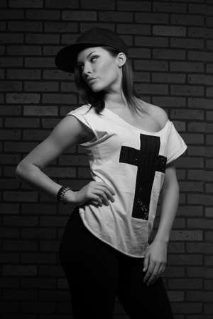 young serious girl posing in a black capの写真素材