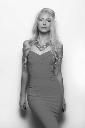 young beautiful blonde in dress on a white backgroundの写真素材