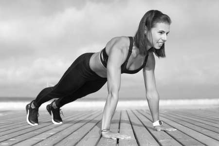 Young strong athletic girl holds a workoutの写真素材