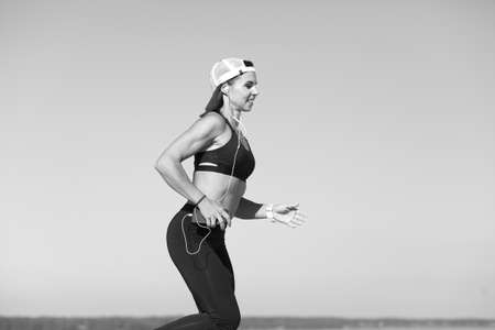 Young strong athletic girl holds a workoutの写真素材