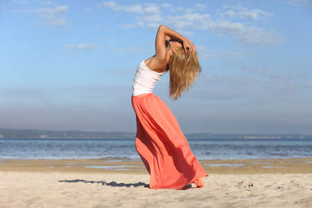 young girl on the sea gets positive emotionsの写真素材