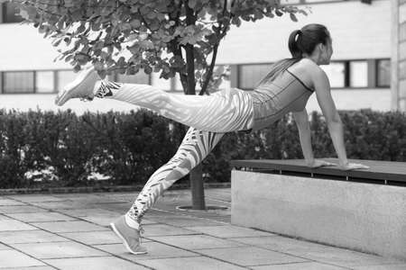 Young strong athletic girl holds a workout