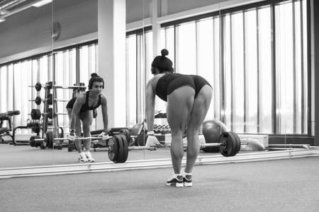 Fitness young sexy girl in the gym doing exercises