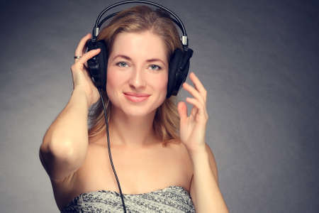 young beautiful girl listening to music on headphonesの写真素材