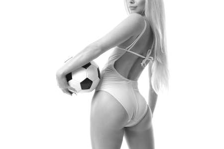 sexy young woman wearing bikini and holding soccer ball.の写真素材