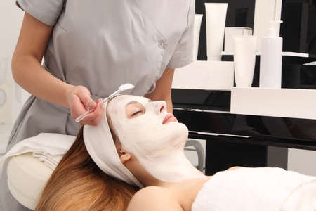 facial treatment of young woman in a cosmetology salonの写真素材