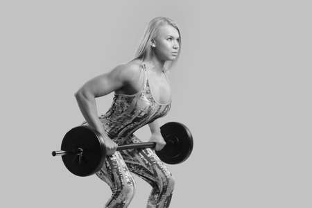 Fitness young girl doing exercises black and white photoの写真素材