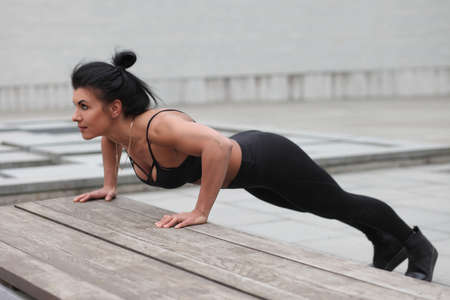 young strong muscular slim girl doing exercisesの写真素材