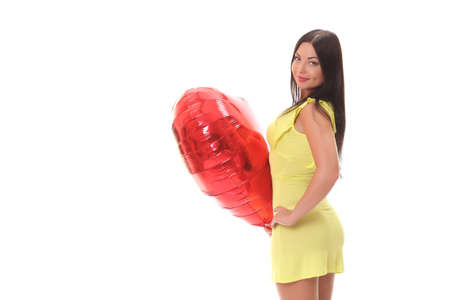 young positive smiling woman holding a big balloon on a white backgroundの写真素材
