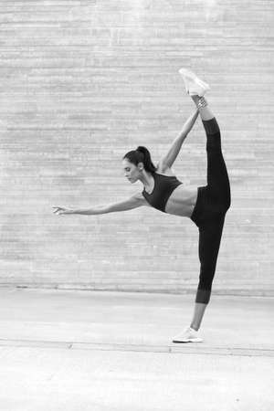 Young attractive female fitness woman performing a twineの写真素材