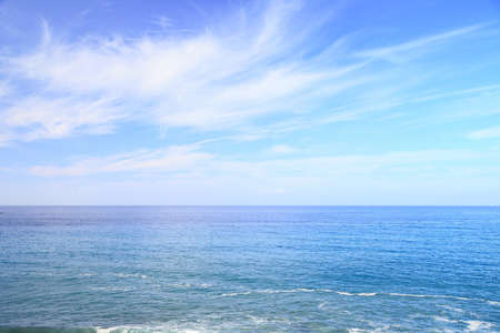 waves on the water of a sandy beachの写真素材