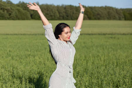 young beauty happy girl walking in the fieldの写真素材