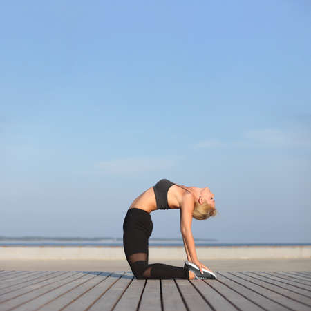 healthy young slim woman practising yoga exerciseの写真素材