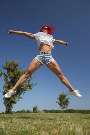 young sexy athletic slim girl is jumpingの写真素材