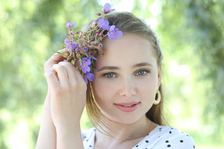 summer portrait of a young cute girl on a green backgroundの写真素材