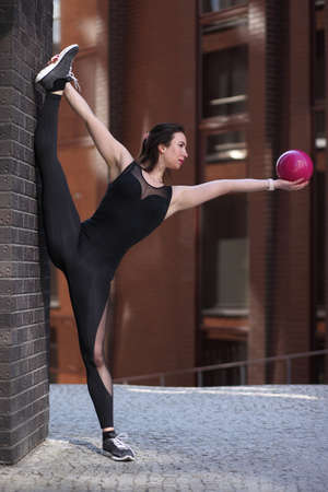young flexible athletic woman is training stretchingの写真素材
