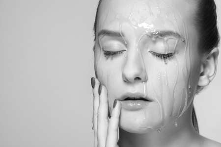 Woman with honey on her face. Honey treatmentの写真素材