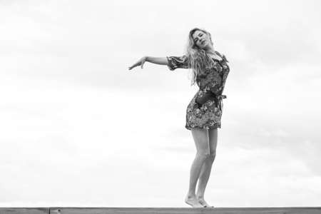 happy girl in a dress by the seaの写真素材