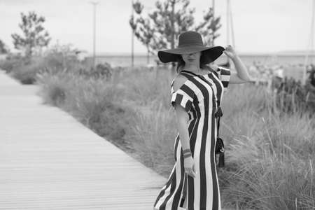 young woman in a long summer dress outdoor walkの写真素材