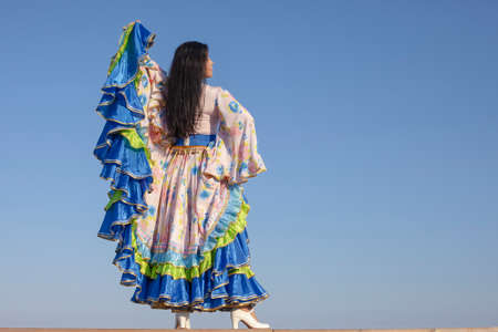 young beautiful woman dancing in gypsy dress