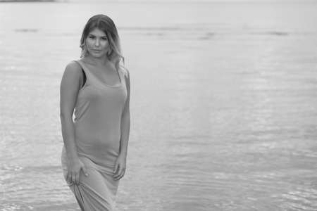 young sexy girl in the water in a dress