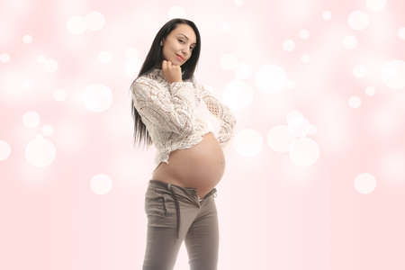 happy young pregnant girl on abstract backgroundの写真素材