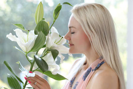 young woman in dress holds a lilyの写真素材
