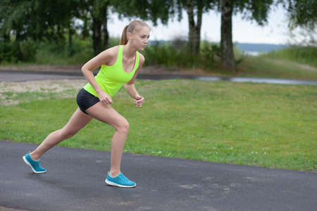 young slender girl sports and workout outdor
