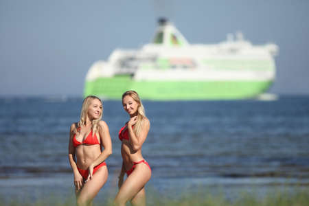 beauty women in red swimsuit on the beachの写真素材