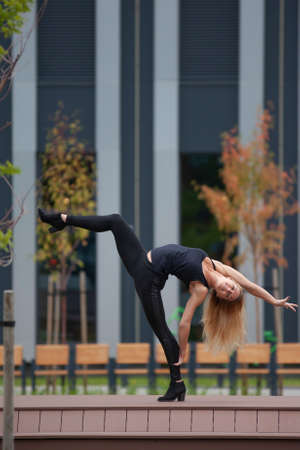 young fitness girl with a sports figure doing stretching