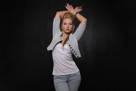 young beautiful woman on black studio backgroundの写真素材